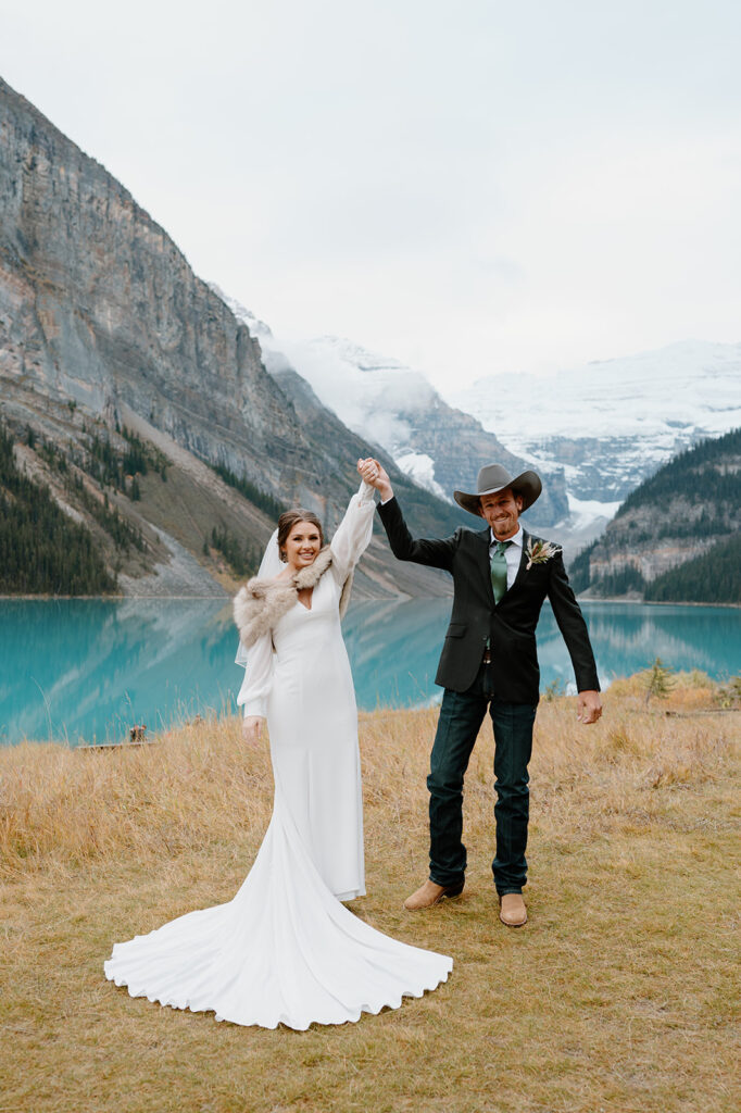 A newlywed couple celebrates their wedding in Banff near Lake Louise. 