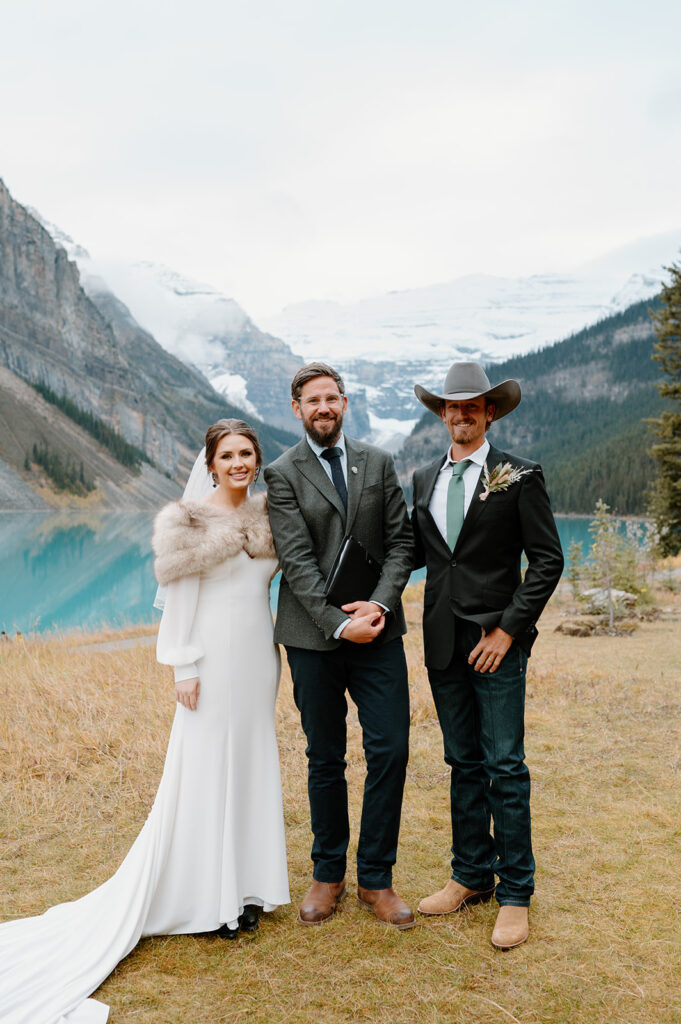 Cole from Married By Cole stands with a Banff elopement couple after officiating their wedding at Lake Louise.