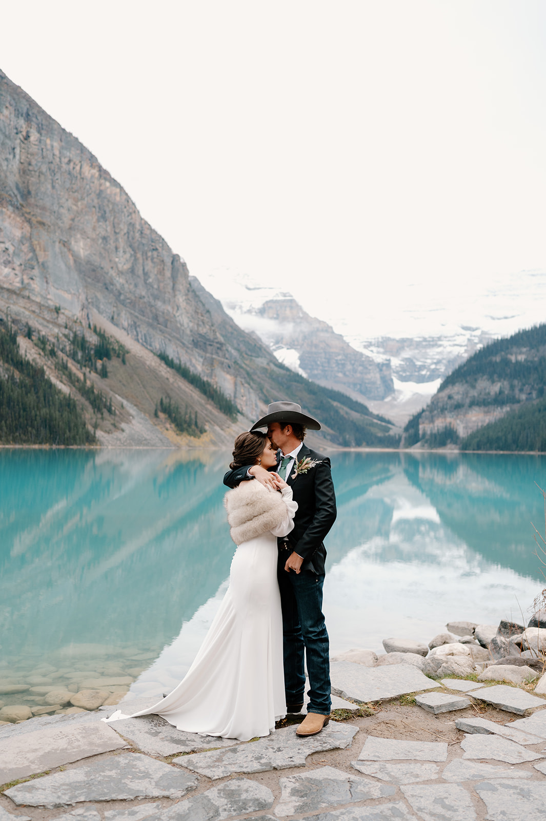 A bride and groom elope in Banff in the Fall at Lake Louise in Alberta.