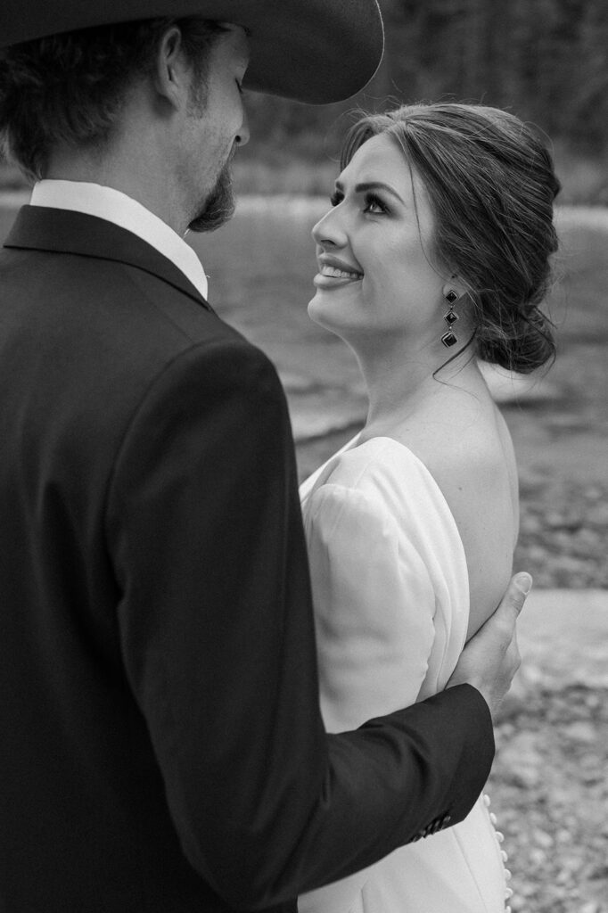 A bride admires her groom just before their Banff vow ceremony at Lake Louise. 