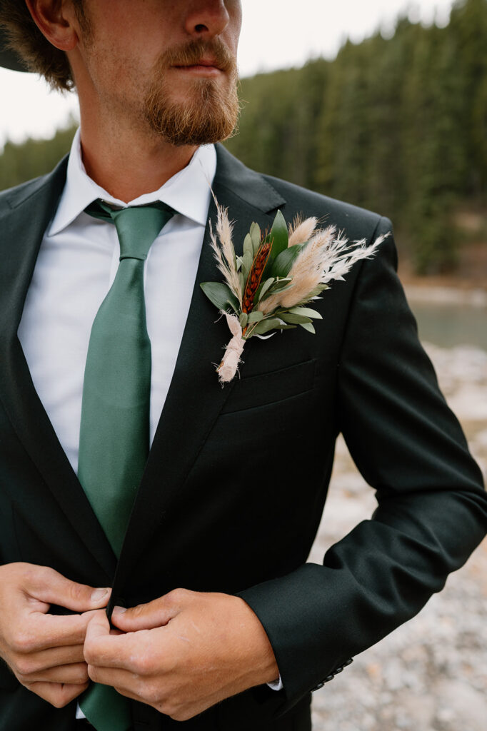 A dried floral boutonniere on a groom's lapel from Adventure Floral at Lake Louise. 