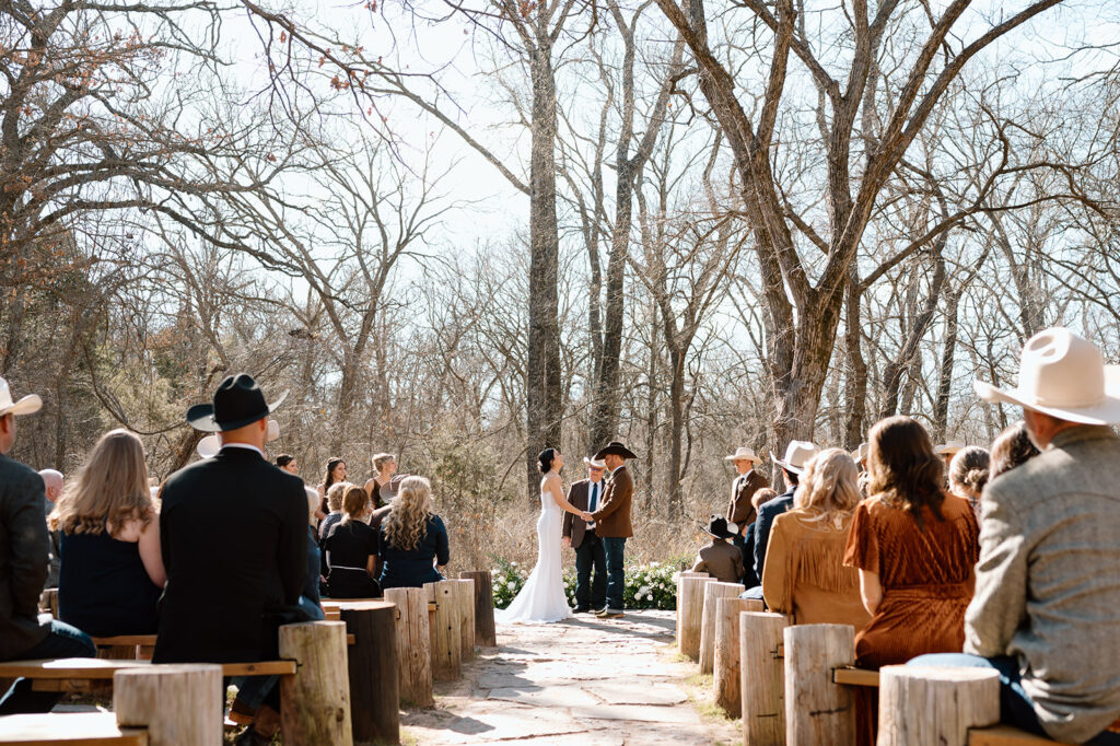 A couple celebrates an outdoor microwedding with friends and family. 