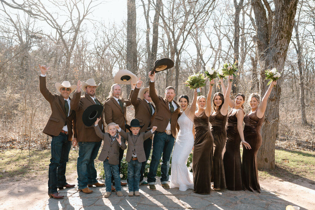 A bride and groom take a celebratory family portrait during their microwedding reception. 