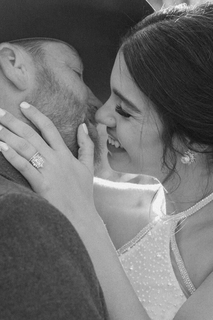 A bride and groom go in for a kiss during their microwedding celebration. 