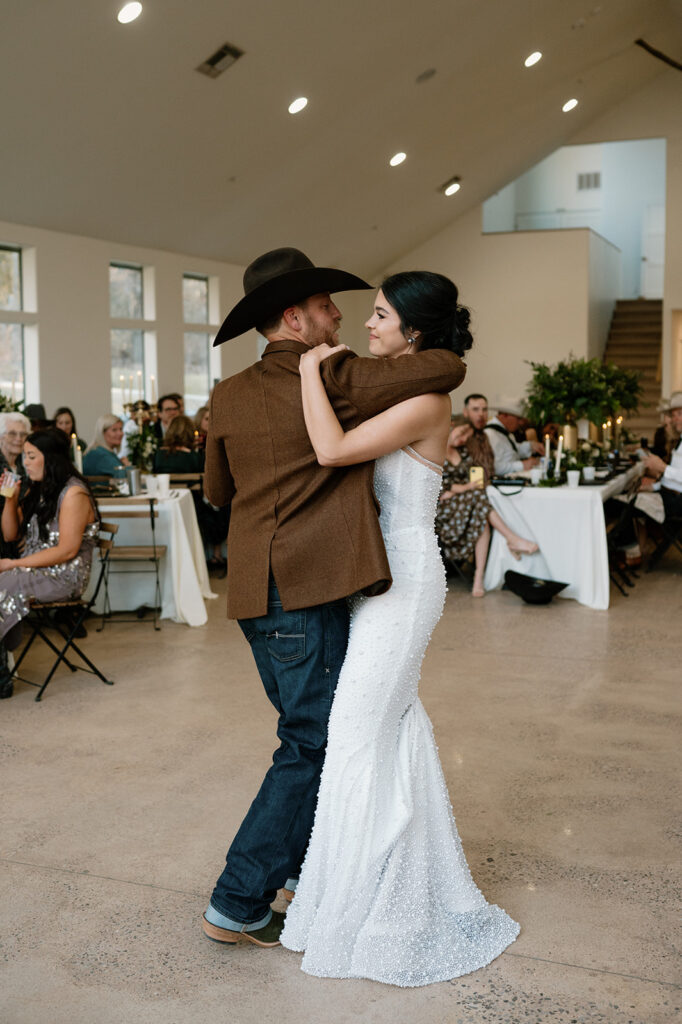 A bride and her groom share a first dance at their microwedding reception. 