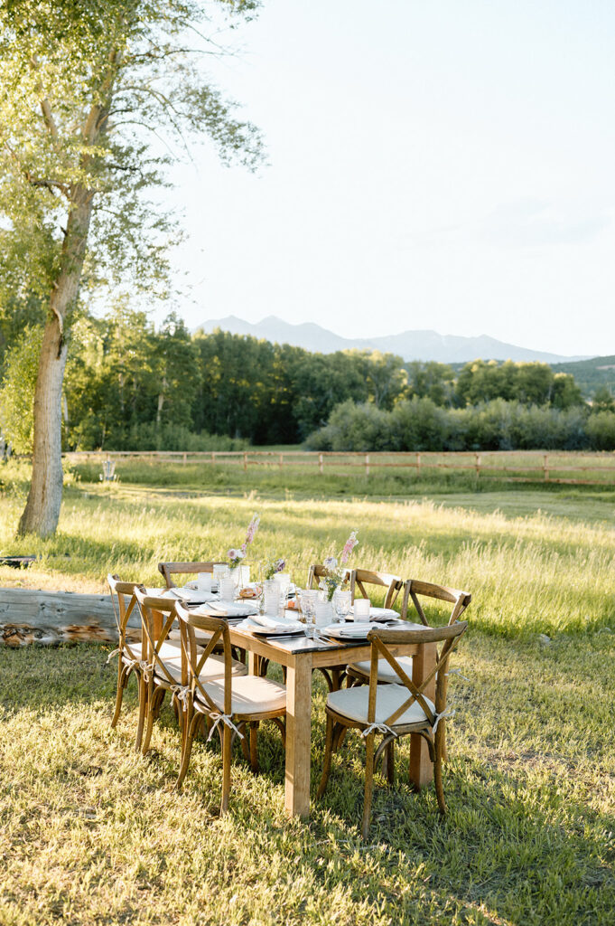 A neutral intimate wedding tablescape in a Colorado meadow at Shaw's River Ranch.