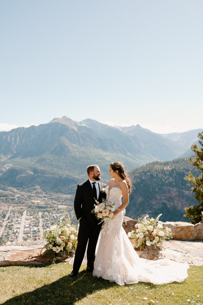 A couple poses for portraits during their wedding at Gold Mountain Ranch.