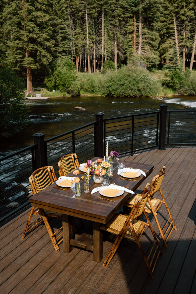 A rustic elopement tablescape setup on a patio near a river at Harmels On The Taylor. 