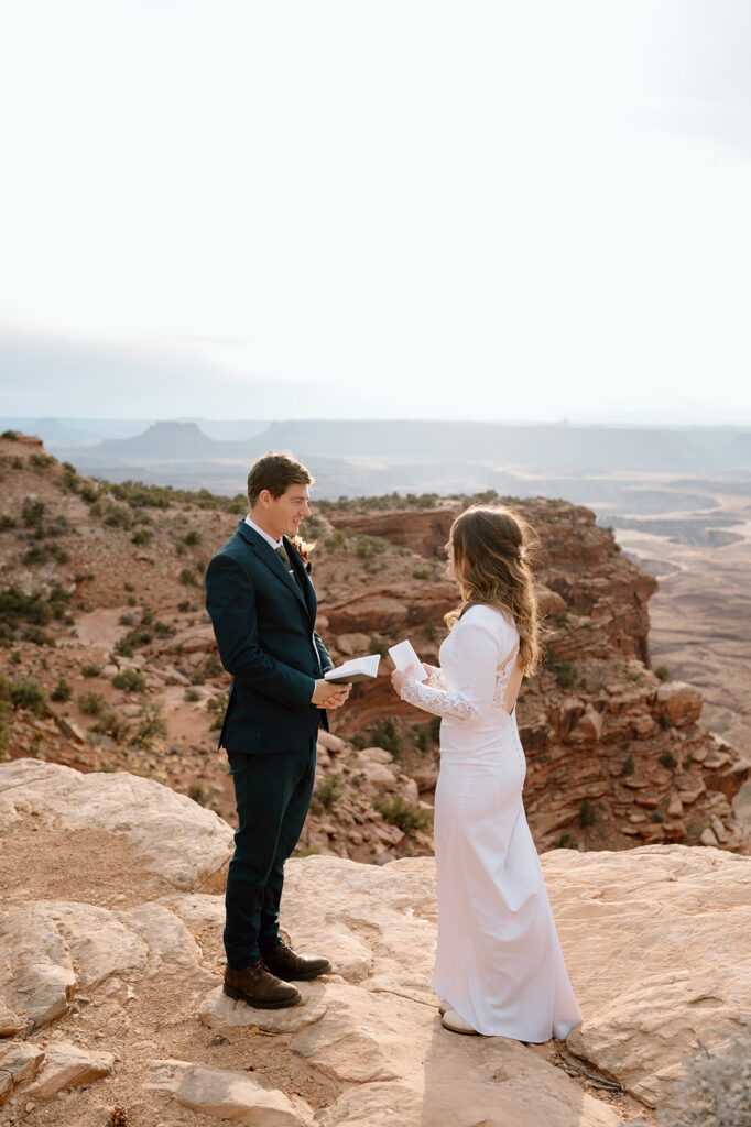 An desert elopement couple exchanges vows at Grand View Point Overlook during their Utah elopement.