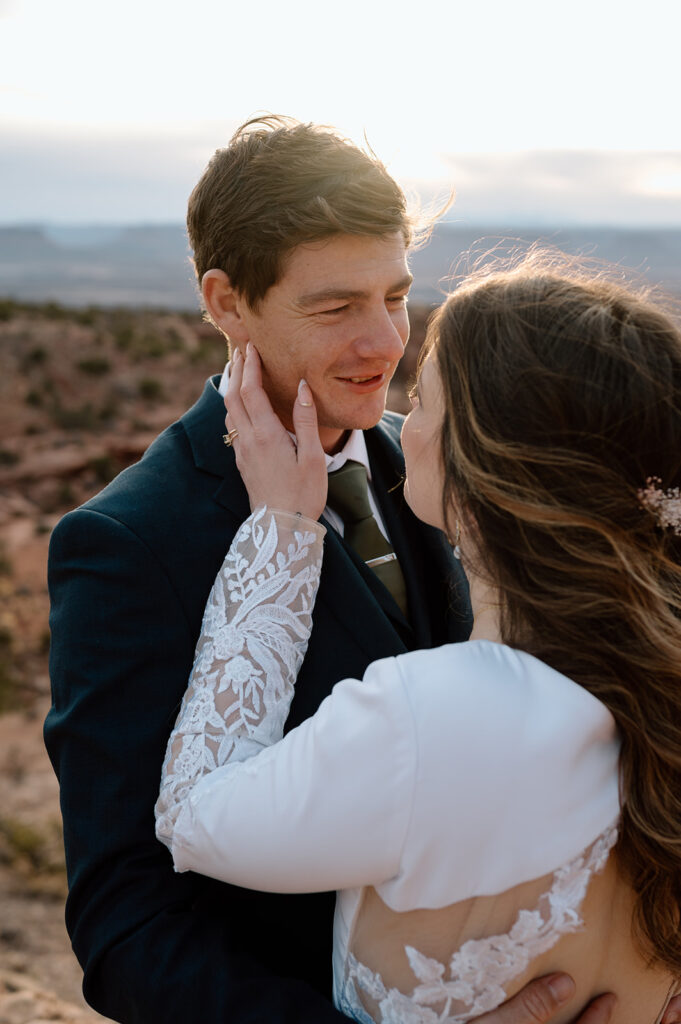 A Moab elopement couple embraces on an overlook in Canyonlands National Park. 