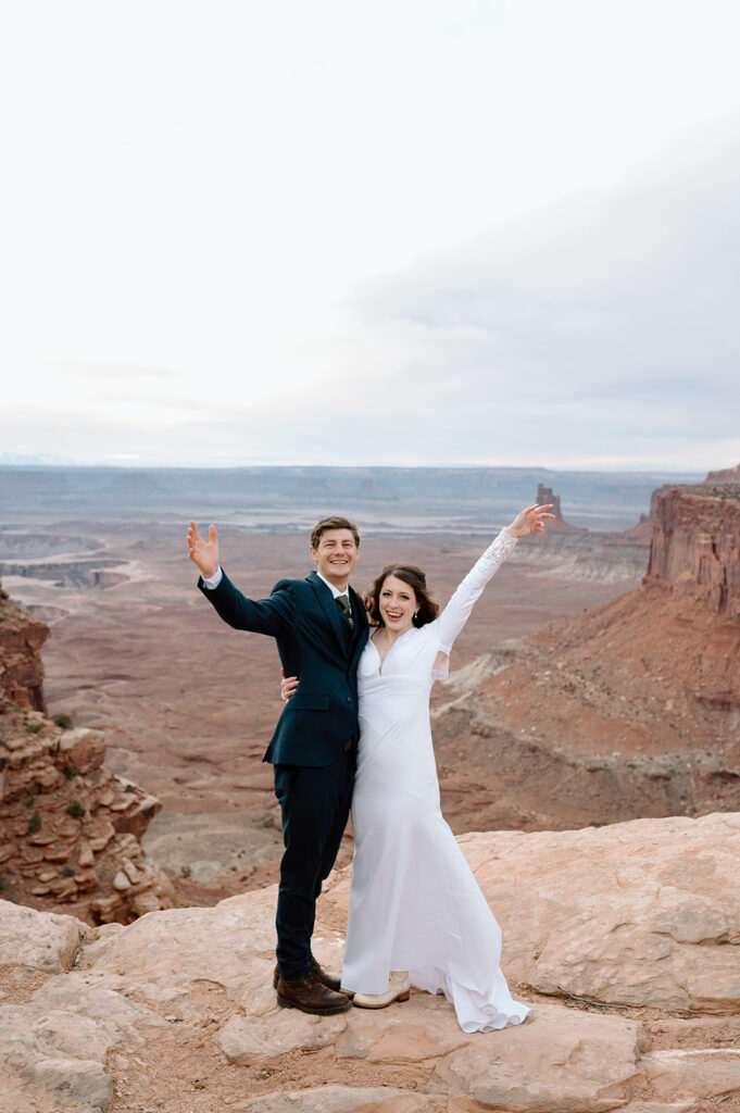 A Moab elopement couple celebrates their vow ceremony on an overlook in Canyonlands National Park. 