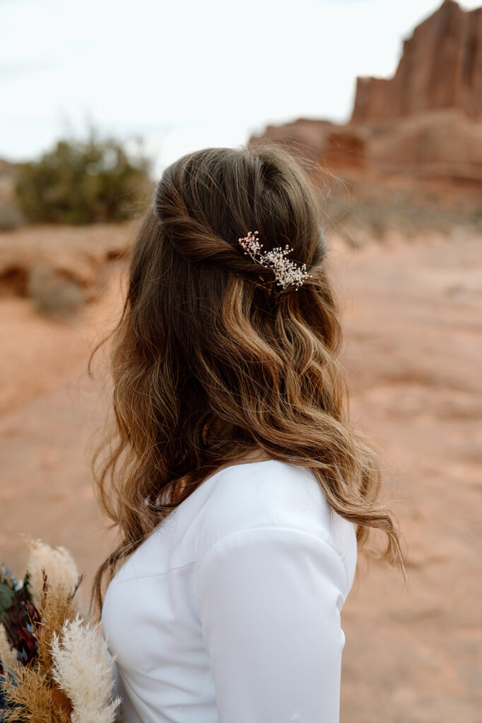 A floral hairpiece styled into a bride's hair.